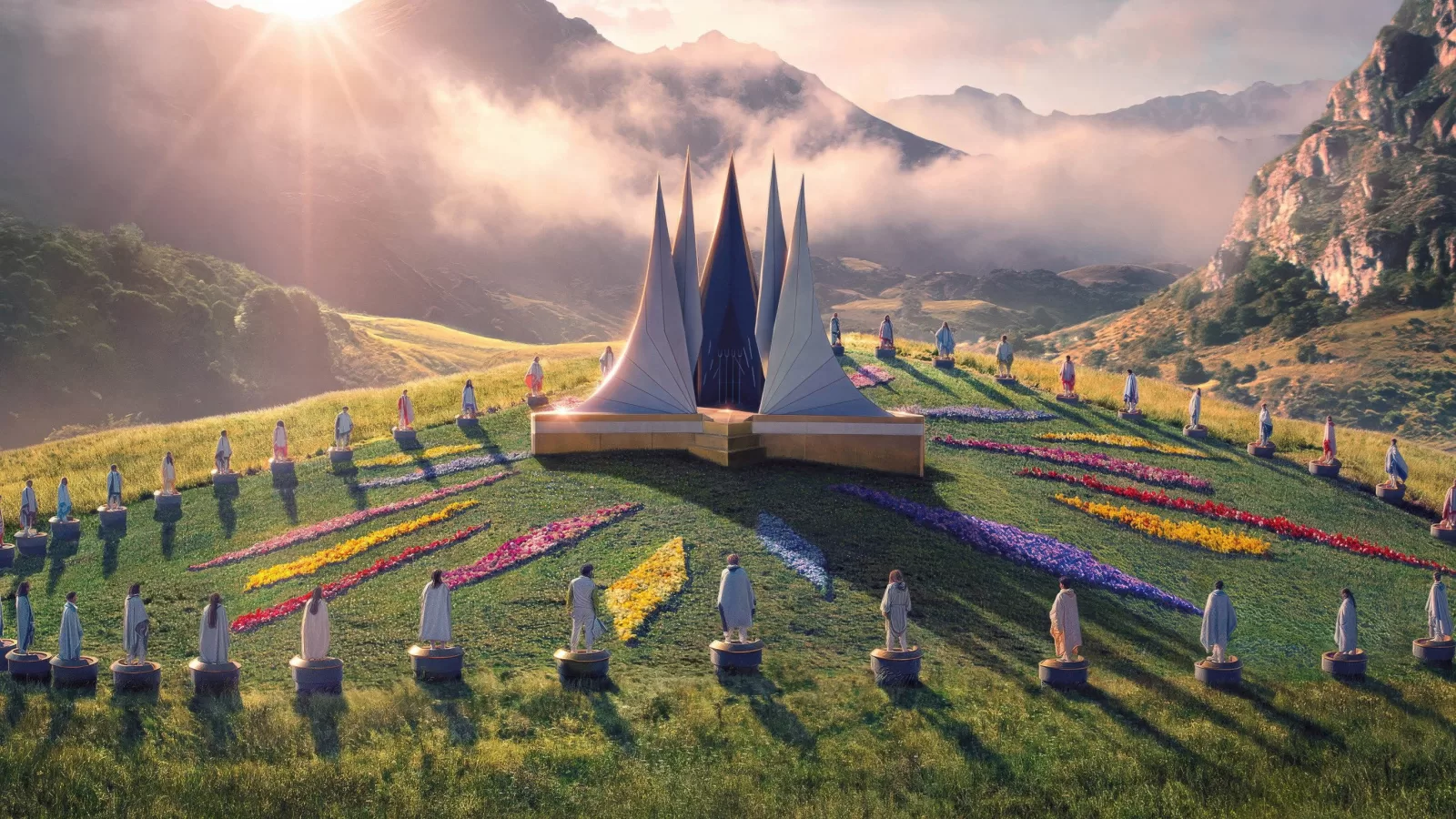 Una arena verde rodeada de montañas con plataformas de tributos dispuestas en círculo alrededor de una estructura central